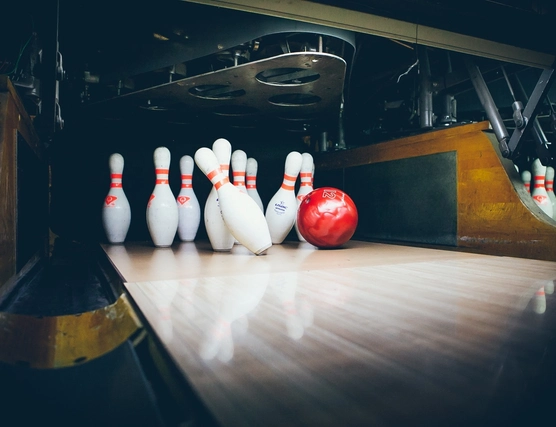 Pins being knocked down by a bowling ball