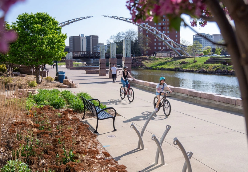 People biking along the Big Sioux River downtown