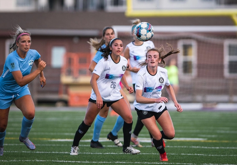 Sioux Falls city FC1 soccer game with women running after the ball