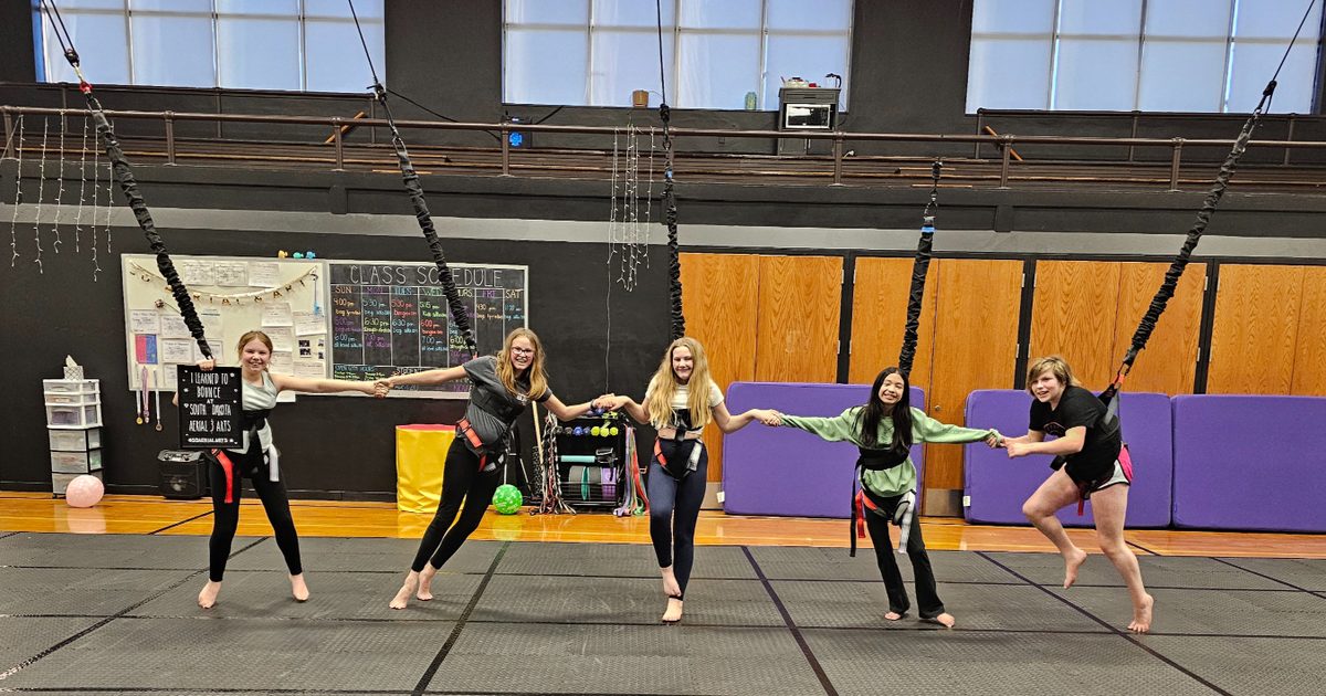 People posing for a photo while doing Aerial Gymnastics at South Dakota Aerial Arts